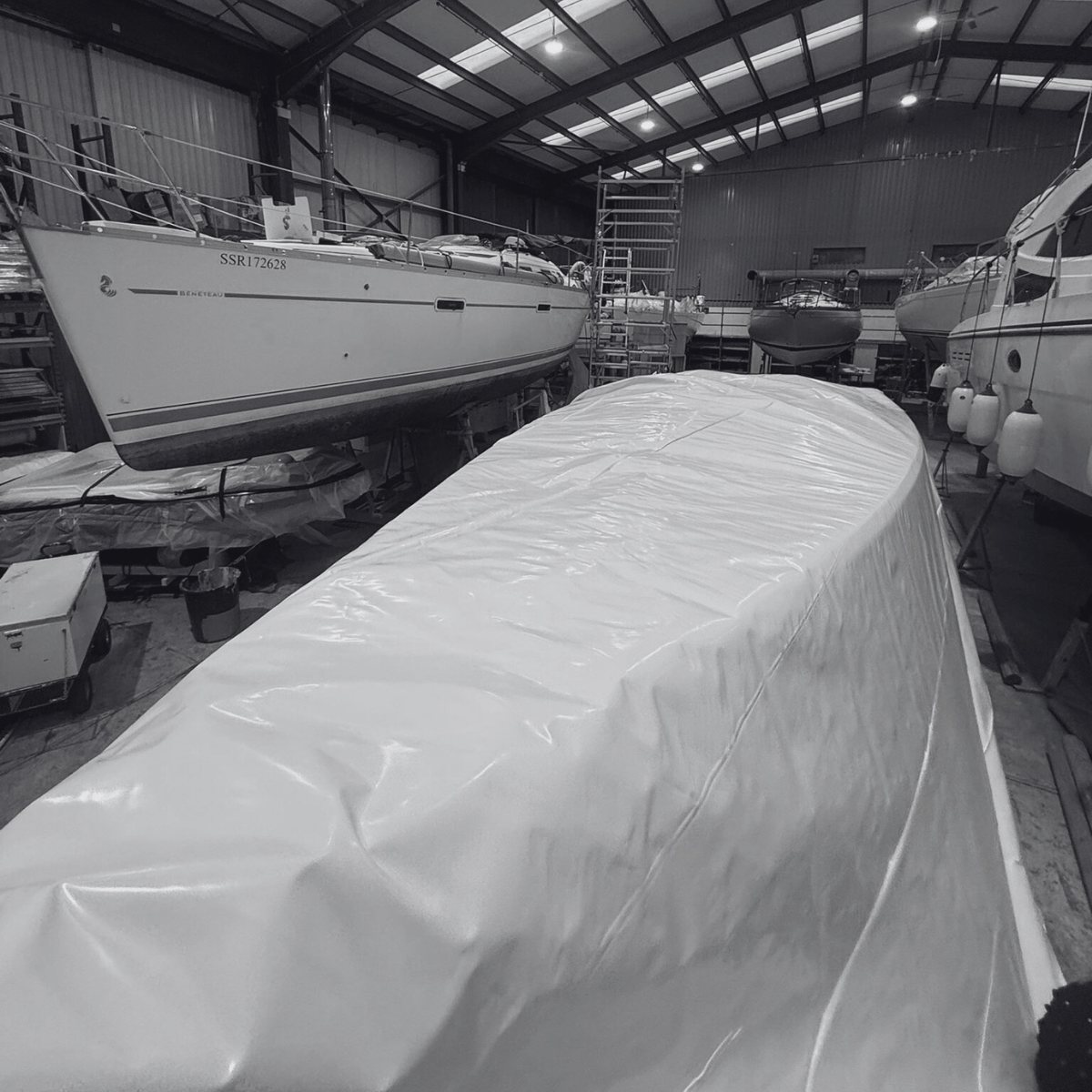 Boats shrink wrapped inside a storage shed