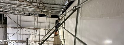 Inside a large shrink wrapped scaffold enclosure