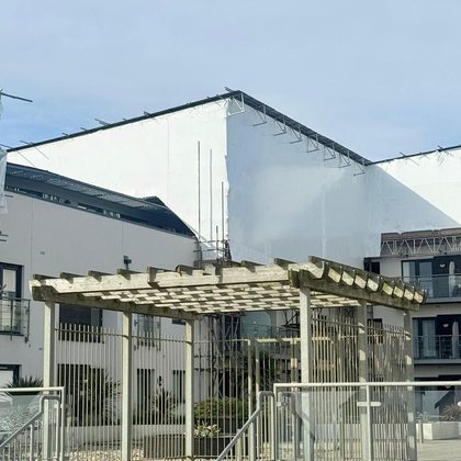 Shrink wrapped structure over a garden pergola