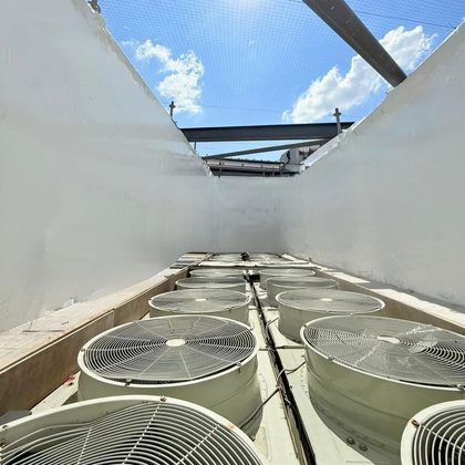 Rooftop plant enclosed in shrink wrap