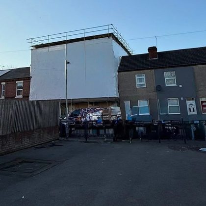 Wrapped building behind a terrace