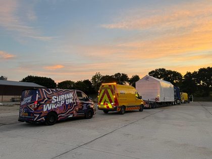 Shrink wrapped abnormal load in convoy at sunrise