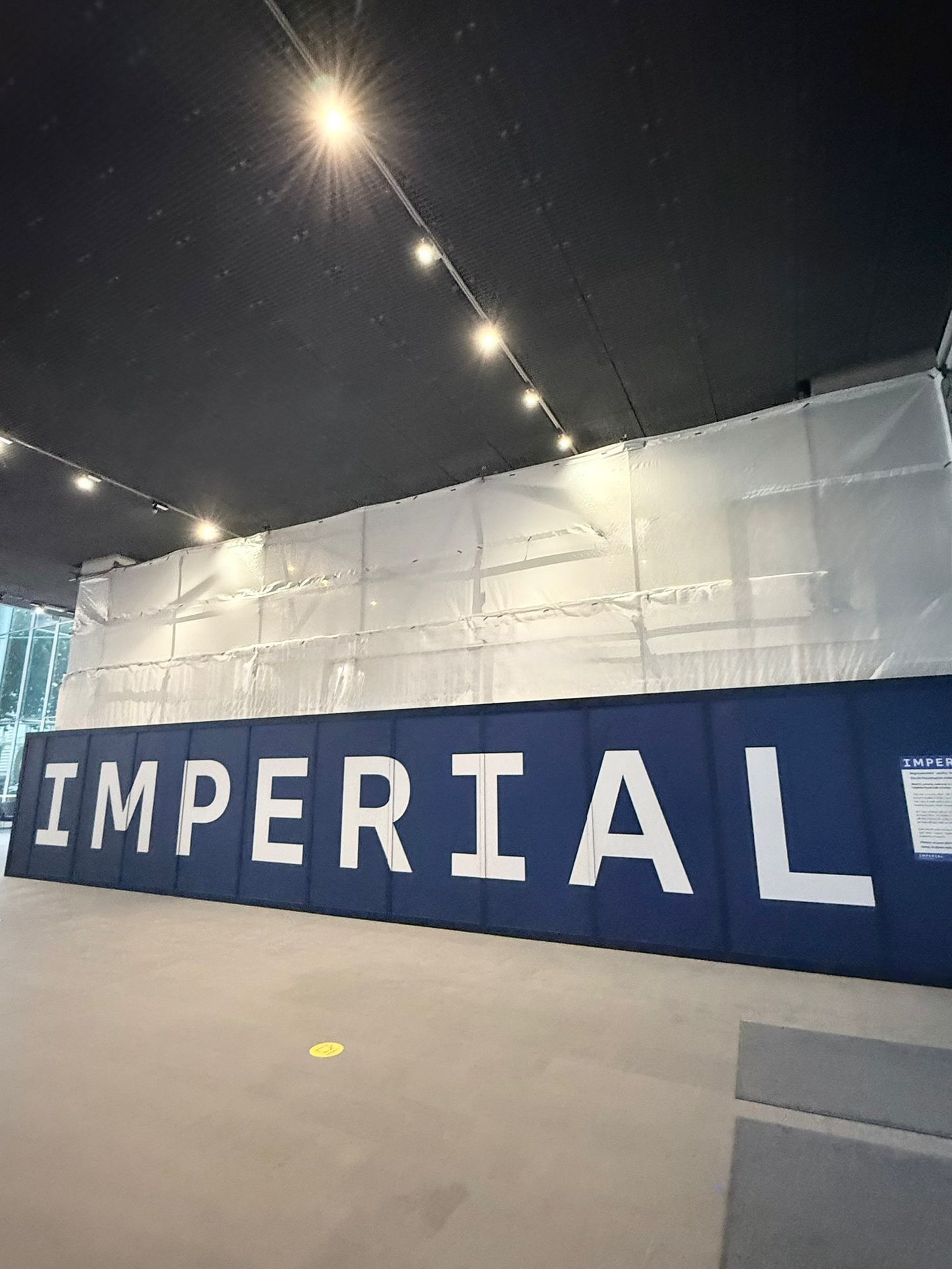 Imperial branded hoarding in front of the shrink wrap