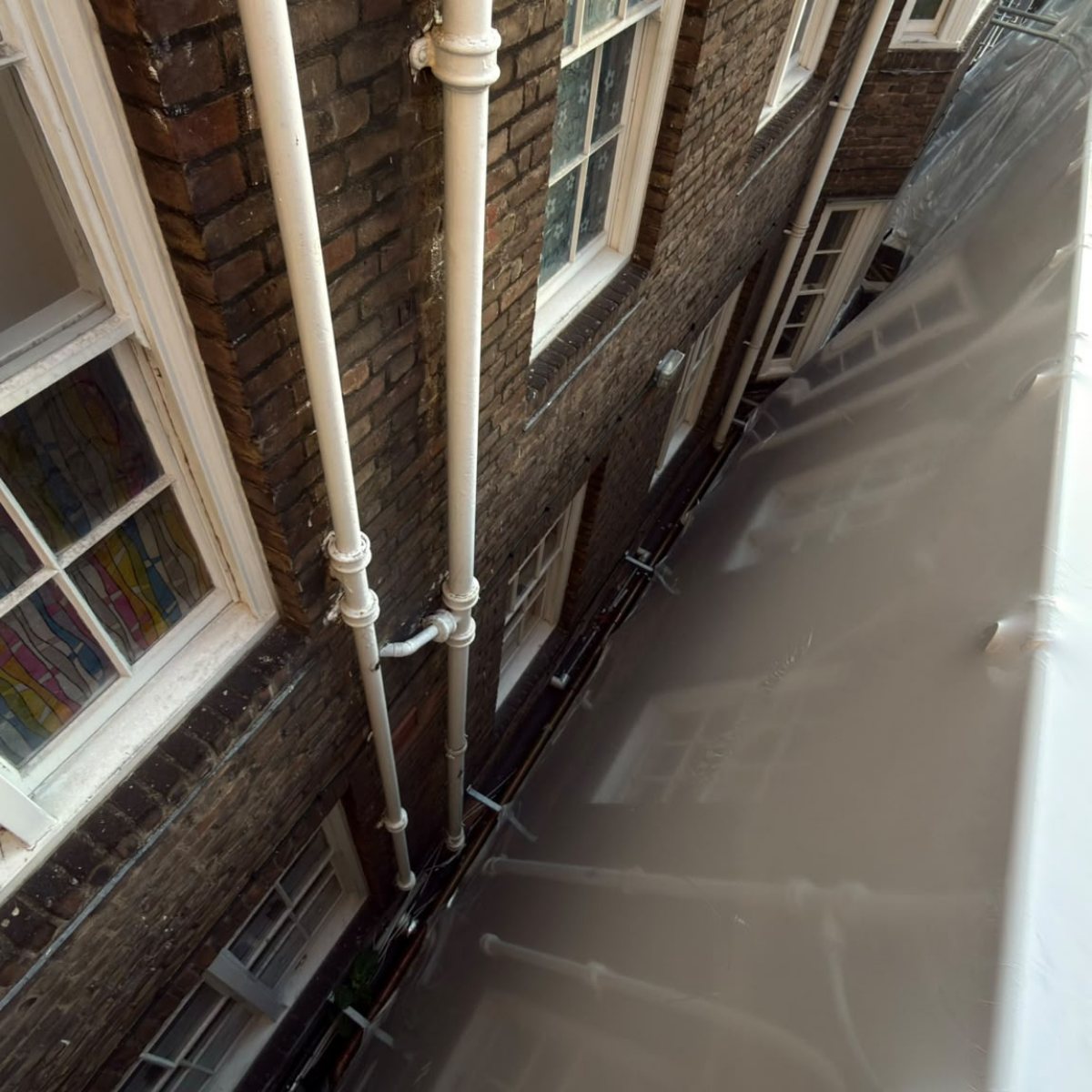 Shrink wrap enclosing the perimeter against the neighbouring building