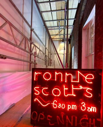 Ronnie Scott's neon inside the wrapped scaffold