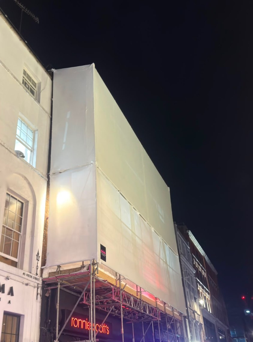 Shrink wrap encapsulation above Ronnie Scott’s Jazz Club on Frith Street at night