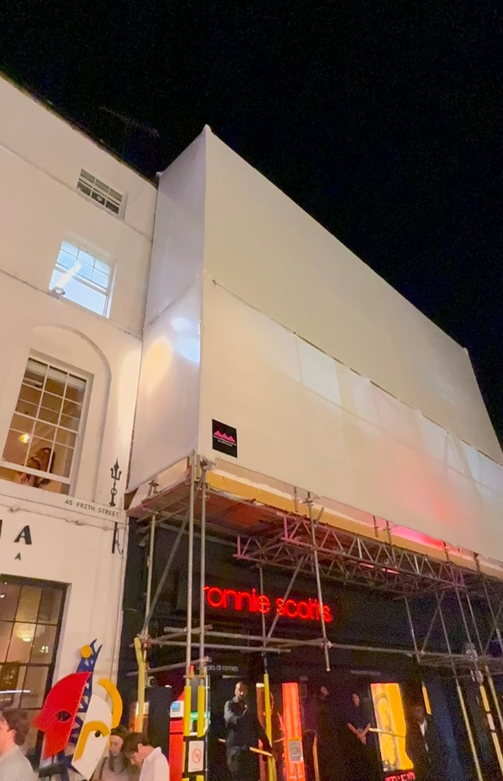 Customers at the Ronnie Scott’s entrance beneath the finished wrap