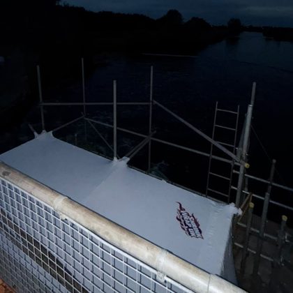 Sandblasting containment enclosure beside the water