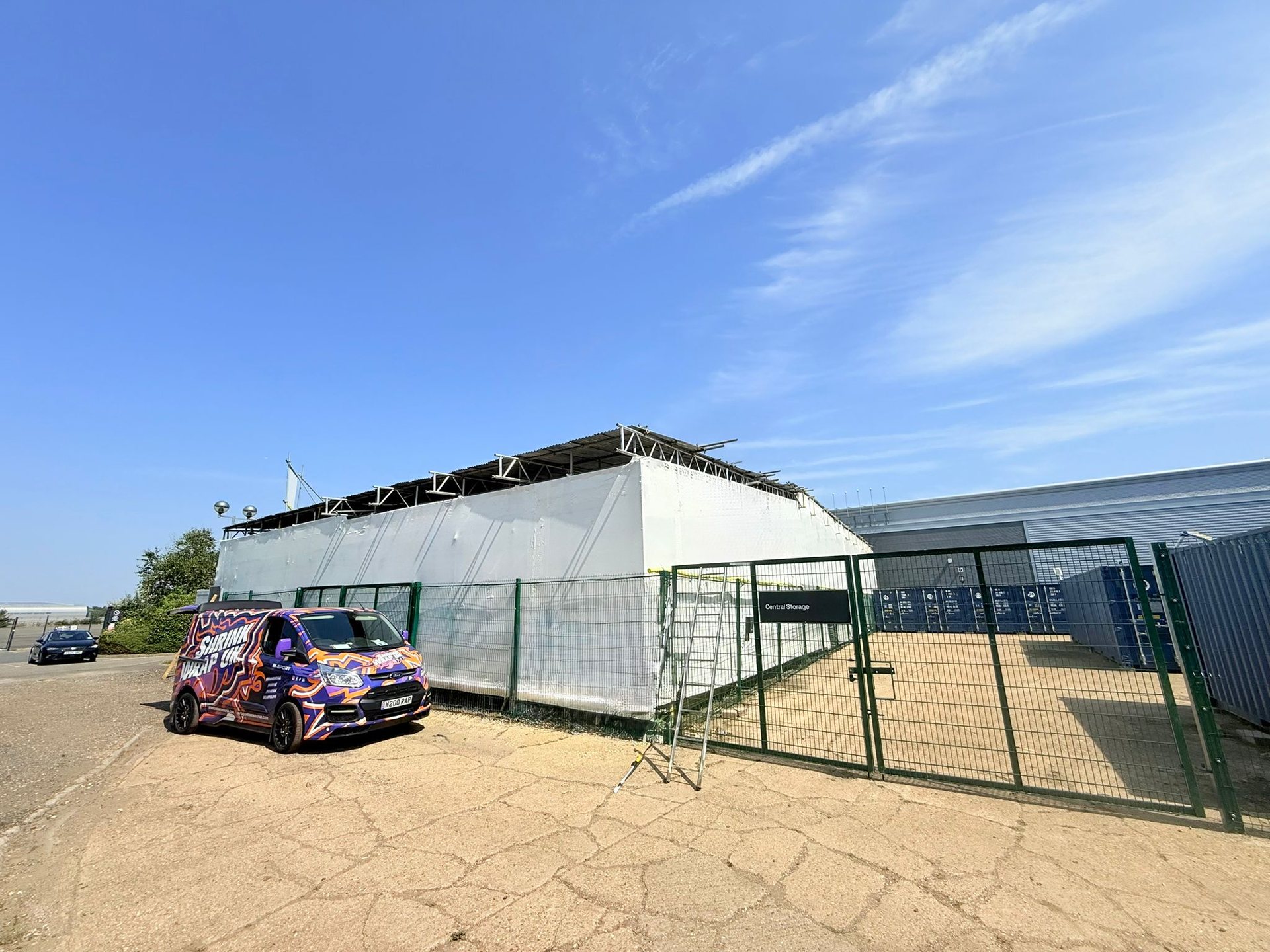 Shrink Wrap UK van beside a wrapped temporary structure