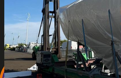 Wrapped yacht lifted in a travel hoist