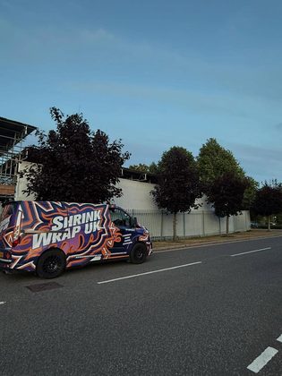 Shrink Wrap UK van outside a wrapped structure