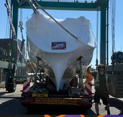 Wrapped hull lifted for road transport